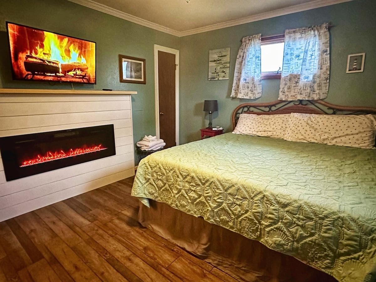 New fireplace brings serenity and warmth to this King Master bedroom with memory foam mattress, large dresser, closet, sound machine, alarm clock, and 40" Roku ready LED TV.